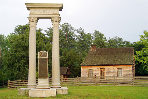 The Unity Monument with the replica of James Bennett's farmhouse in the background.