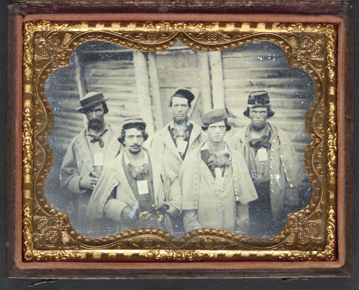 The prisoner second from right sports a hat with a similar style. Entitled, “Five unidentified prisoners of war in Confederate uniform in front of their barracks at Camp Douglas Prison, Chicago, Illinois.” Courtesy of the Library of Congress.