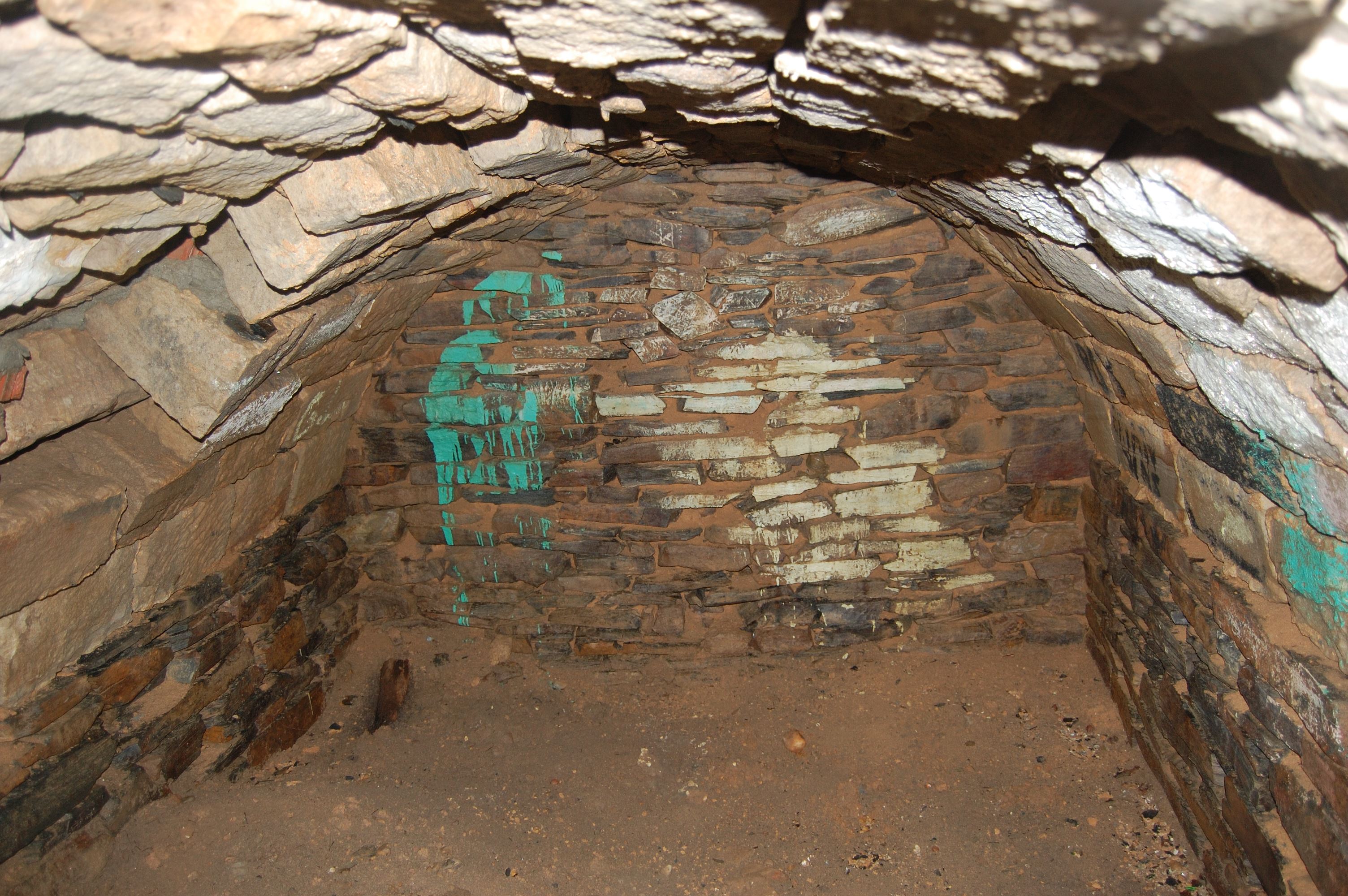 WOODBRIDGE, VA - AUGUST 13 : Prince William County staff breached the east wall of Grayson's tomb, photographing and video taping  the interior. No human skeletal remains were observed. The west wall of the tomb is seen here and shows various periods of construction and repair. William Grayson, lawyer, first and only U.S. Senator from Prince William County and delegate to the Constitutional Convention, is buried on property formerly part of "Belle Air" the family plantation. Grayson organized Prince William county's first revolutionary militia unit in 1774. Now his  grave is falling apart, has gone through a lot over the years, possibly blown up in the Civil War, spray-painted by vandals who climbed inside the tomb  and is now being fixed because a private citizen who really cares about graves paid for the supplies and the county agreed to do the work. (Photo by Justin S. Patton/Prince William County Planning Office)