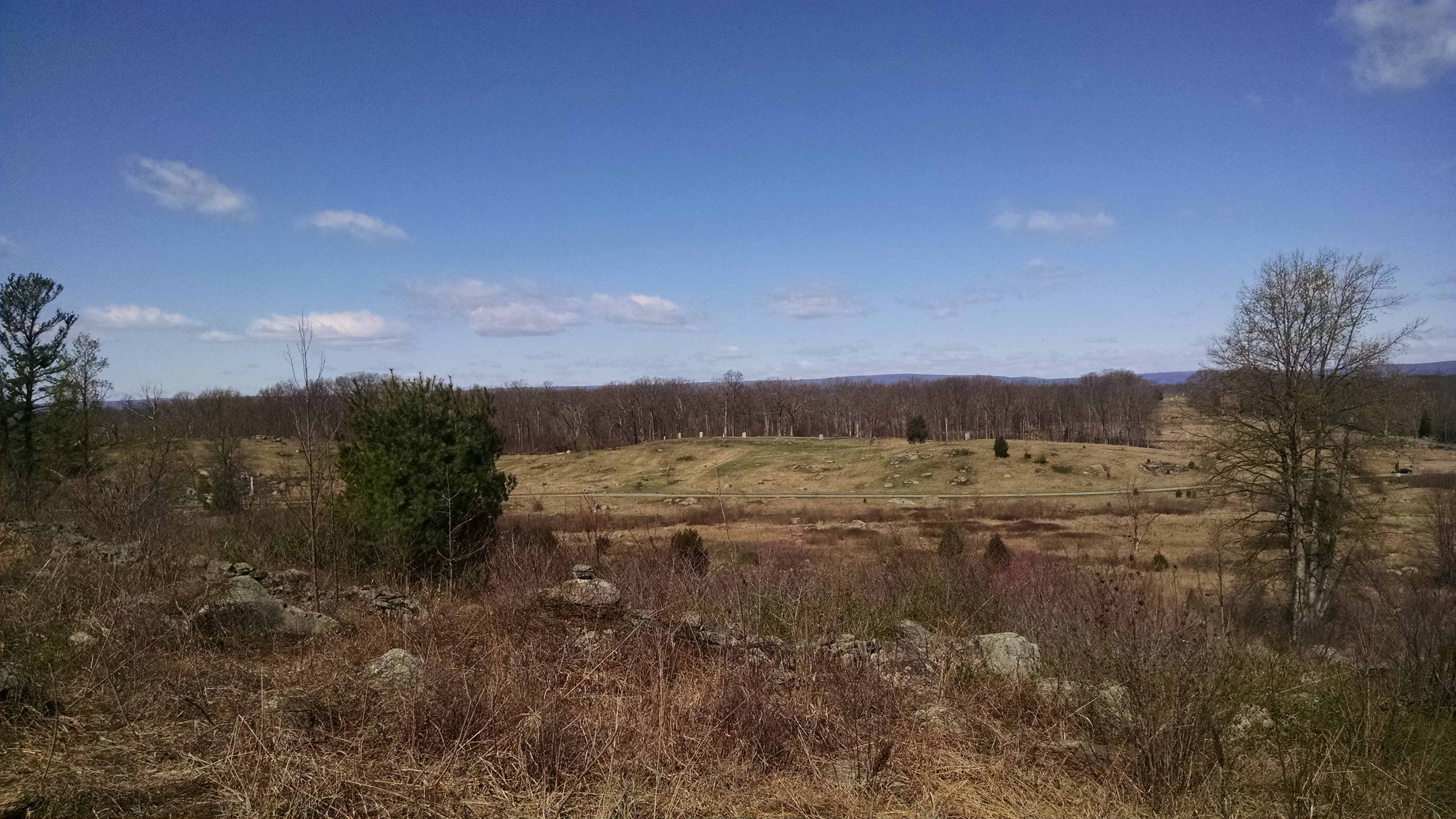 View from Gibbs' position looking west to Houck's Ridge and the Wheatfield. Monuments to the U.S. Regular regiments dot Houck's Ridge. The Regulars withdrew from the Wheatfield beyond the far tree line to the area where the picture was taken.
