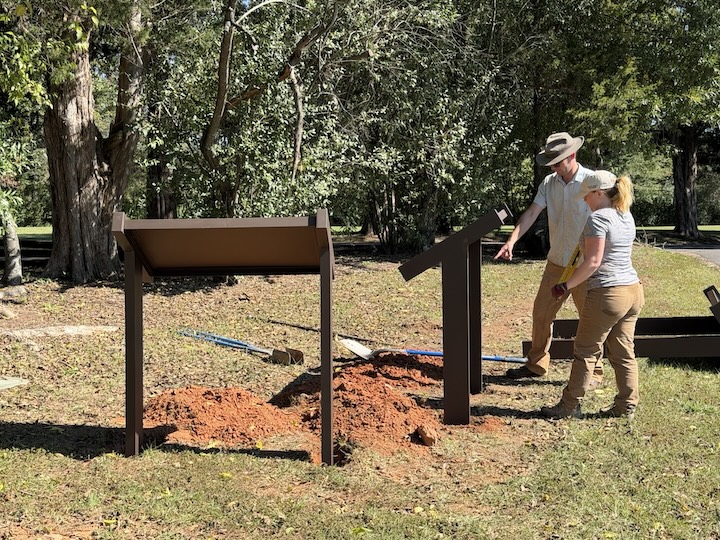 Chris Brown, pointing, discusses placement of the third sign with Ashley Bissetti